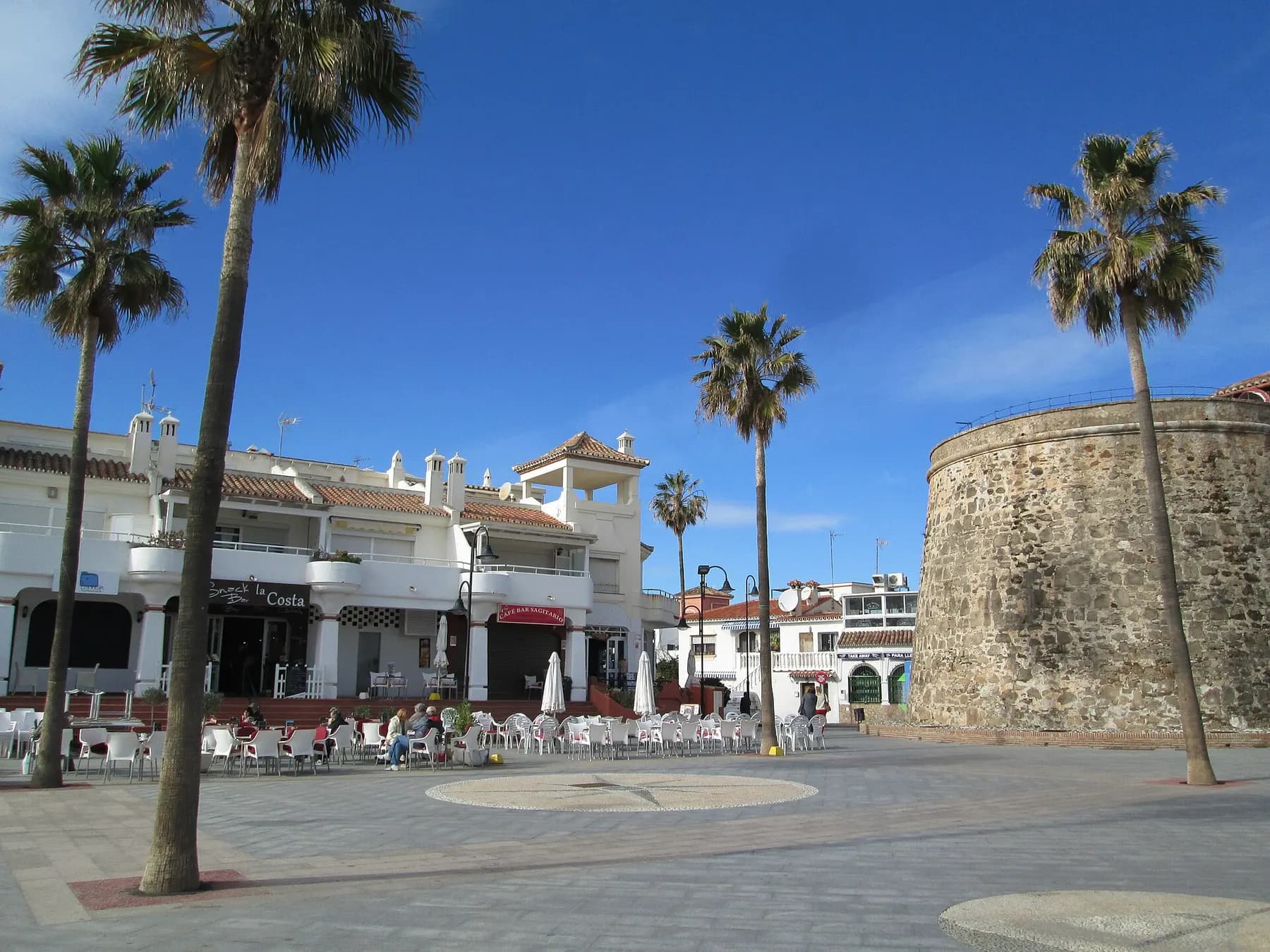 Palm-lined square in La Cala de Mijas next to the Torreón de La Cala watchtower