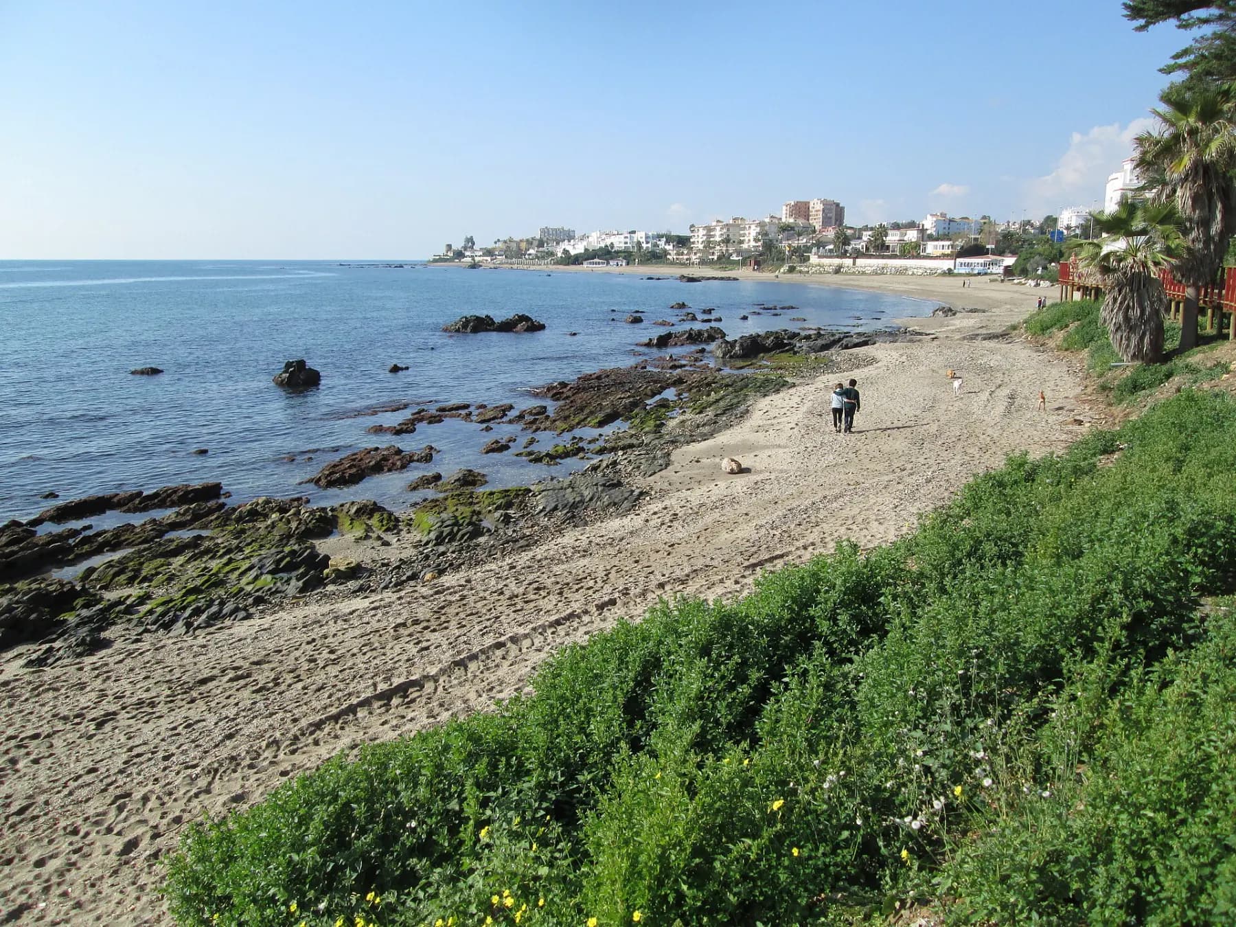 Sandy beach and rocky shoreline on the Mijas Costa coast, Costa del Sol